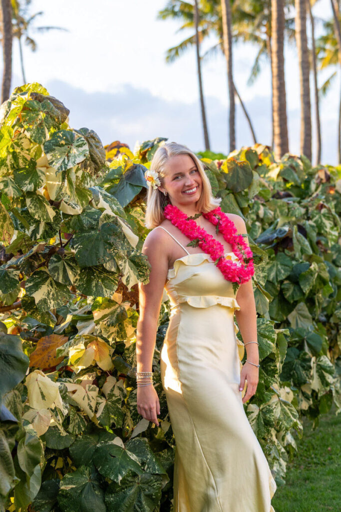 Close-up of a senior girl laughing with palm trees in the background