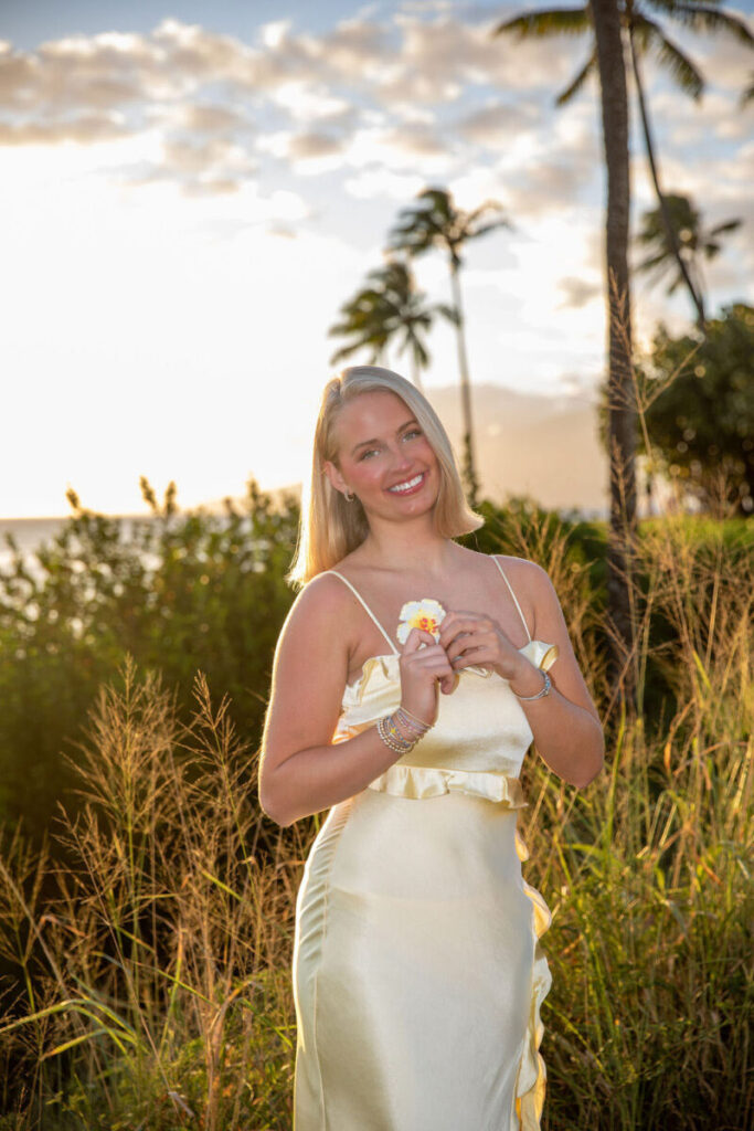 Senior girl posing confidently near lush greenery at Kapalua Beach