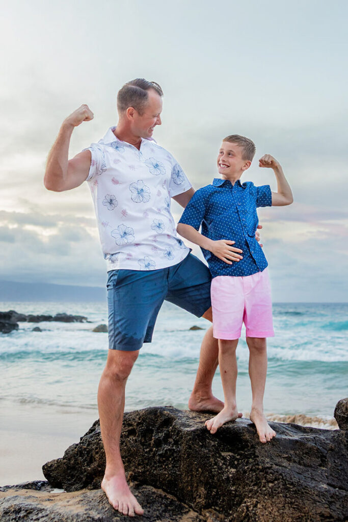 dad and son posing together on Maui beach