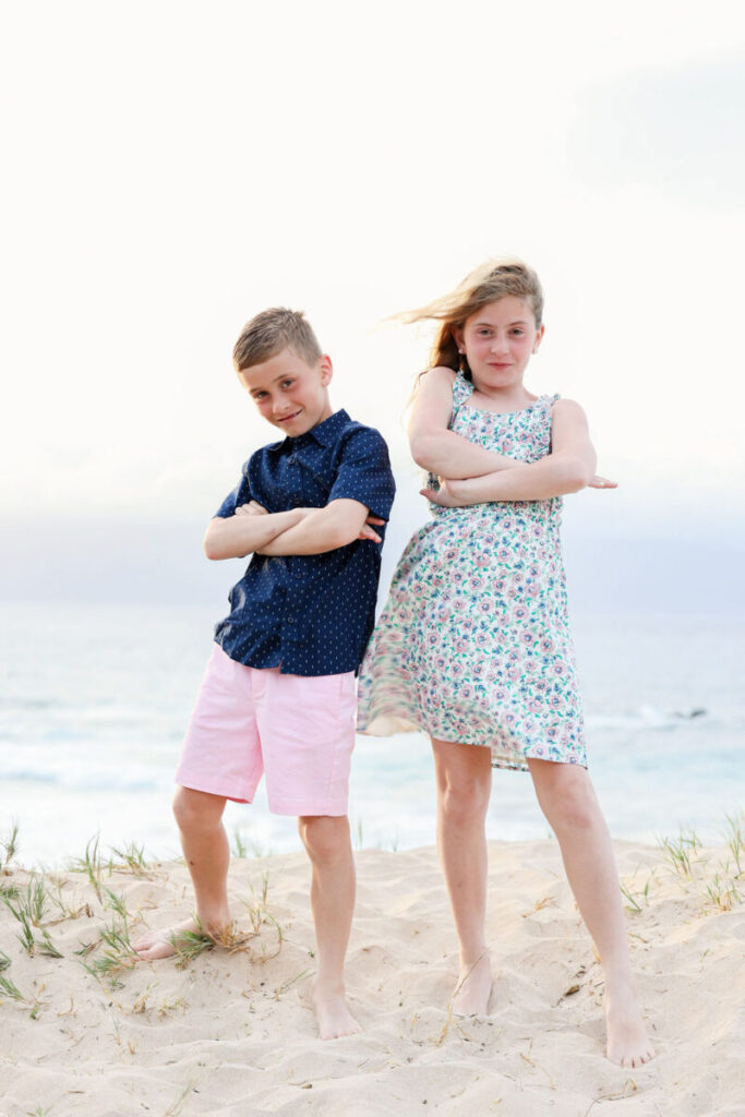 kids playing in the sand, laughing together on the shoreline