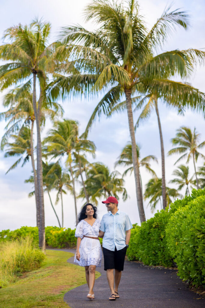Serene Maui sunrise with a couple walking Kapalua beach