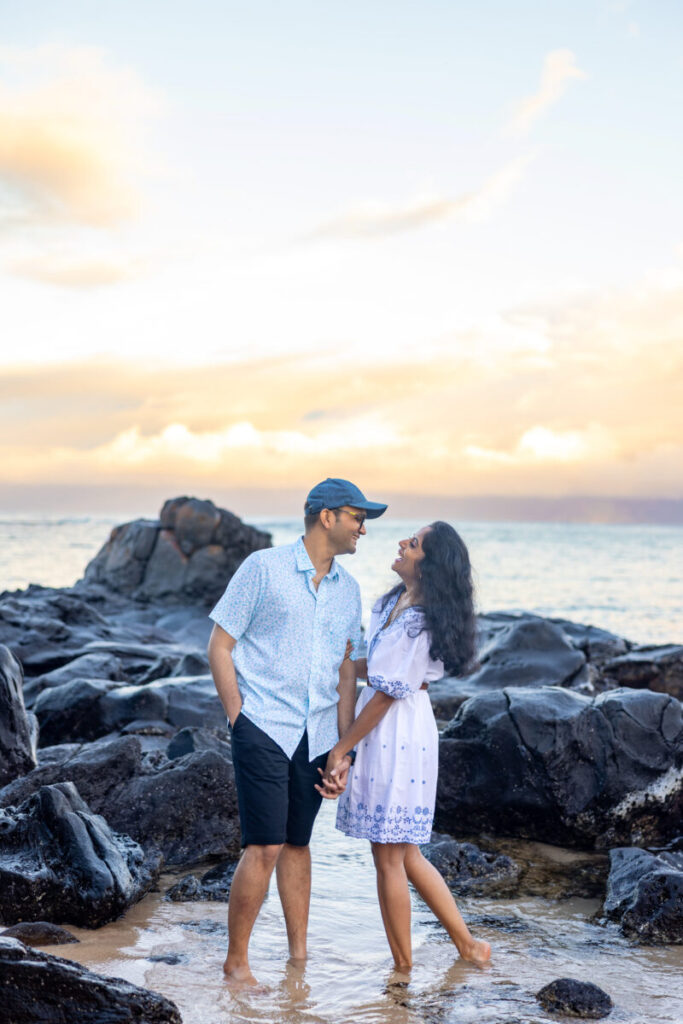 Serene Maui sunrise with couple in the water