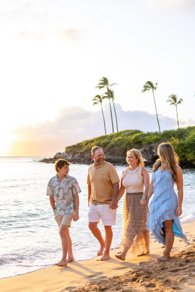 family walking at Maui sunset session at Kapalua beach
