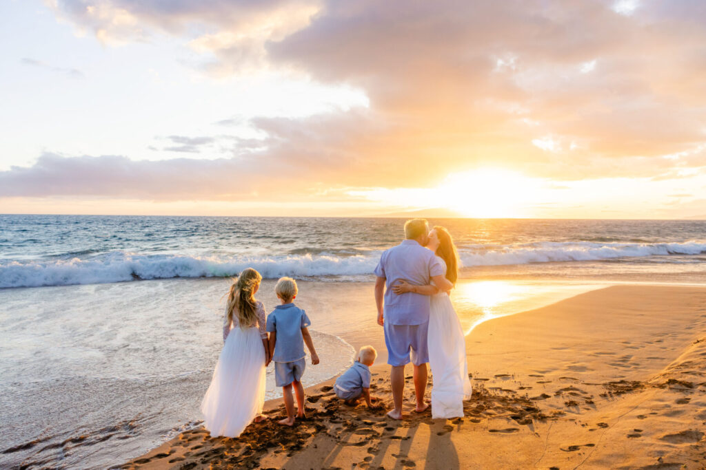 family of five hugging on Poʻolenalena Beach
