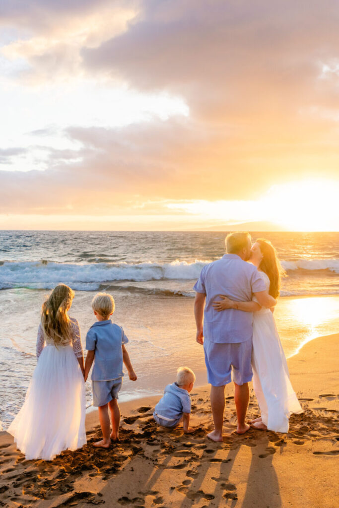 Wailea family photography at sunset with a family of five hugging on Poʻolenalena Beach