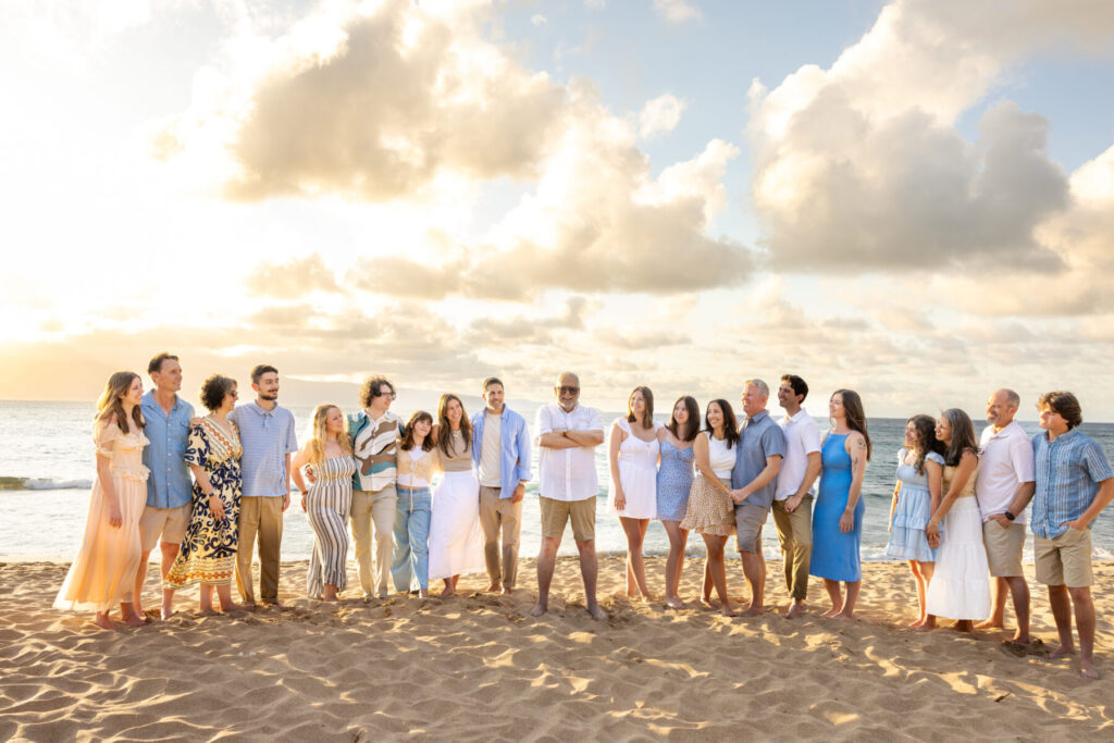Portrait of a family at DT Fleming Beach framed by sunset colors and ocean waves