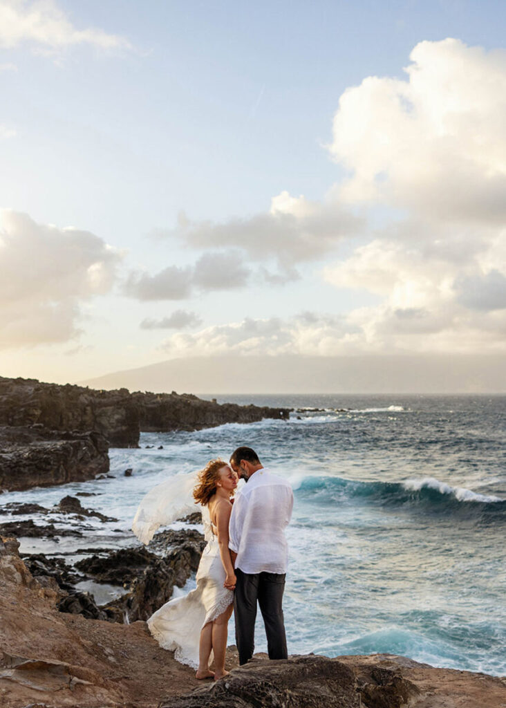 Dramatic clouds and crashing waves during sunset at Ironwoods Beach, Maui