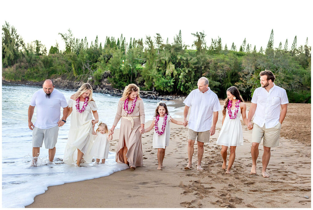 Family coordinated in soft pastel colors during Maui beach portraits