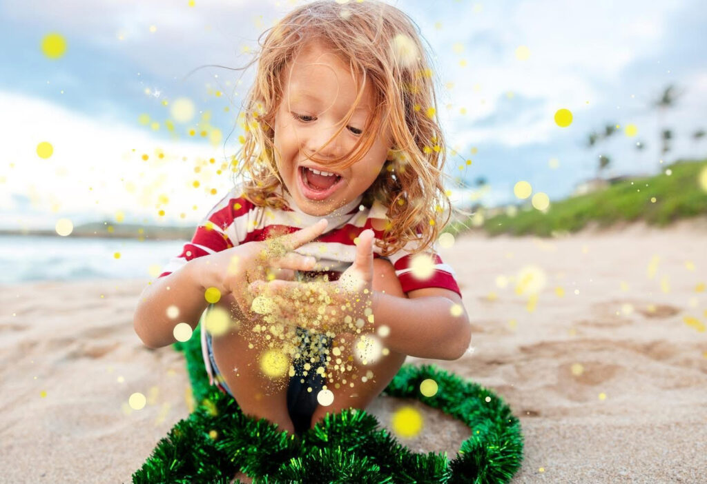  child playing on the shoreline, creating timeless holiday cards in Maui