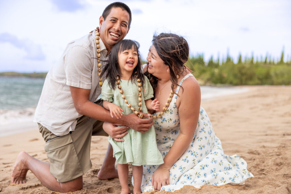 Family coordinated in soft pastel colors during Maui beach portraits