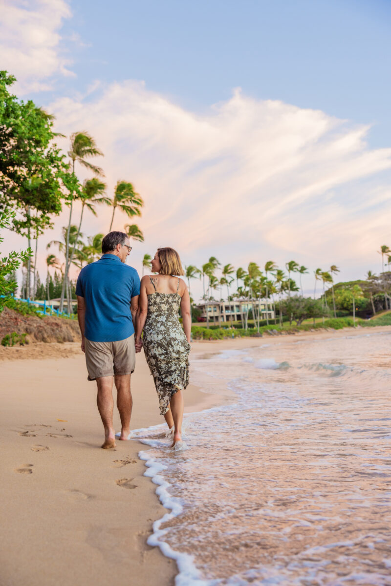 Couple wearing a dress and linen shirt during Maui beach photoshoot at sunset