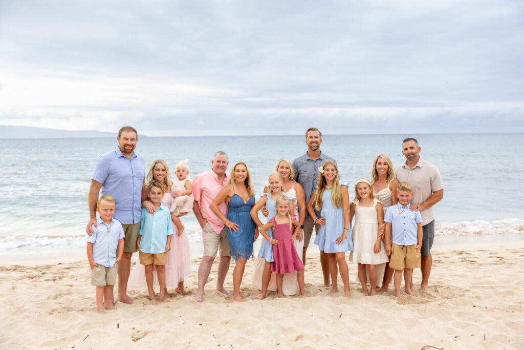 Family coordinated in soft pastel colors during Maui beach portraits