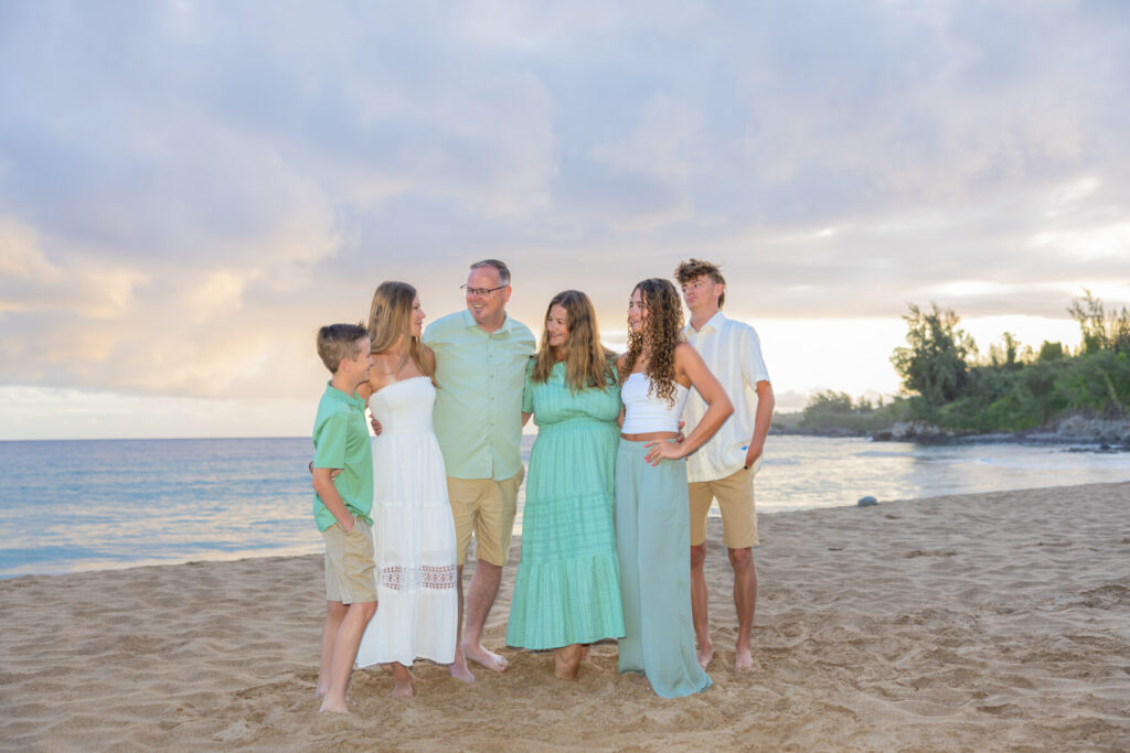 Family coordinated in soft pastel colors — what to wear for a Maui beach photoshoot with kids