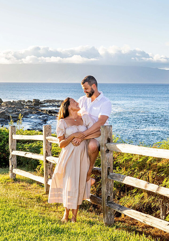 Couple gazing into each other’s eyes during a Maui couple photo session at Kapalua Bay, framed by golden light and ocean views.