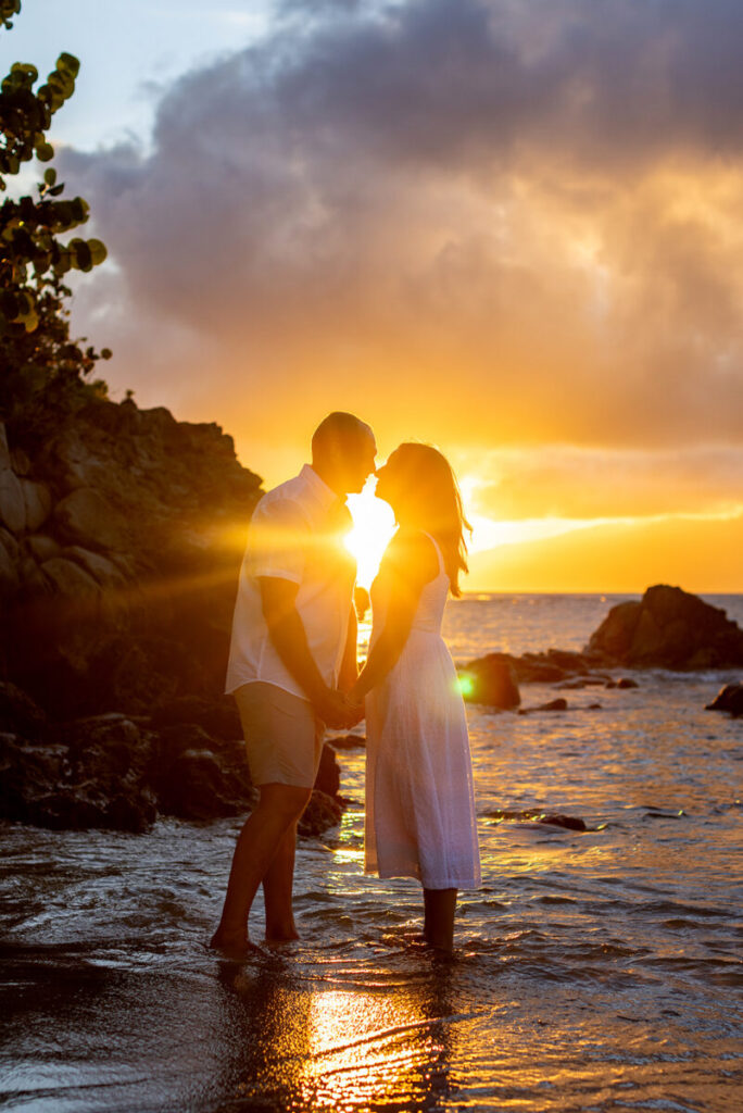 Silhouette of a couple during a Maui couple photo session at Kapalua Bay with a glowing sunset sky.