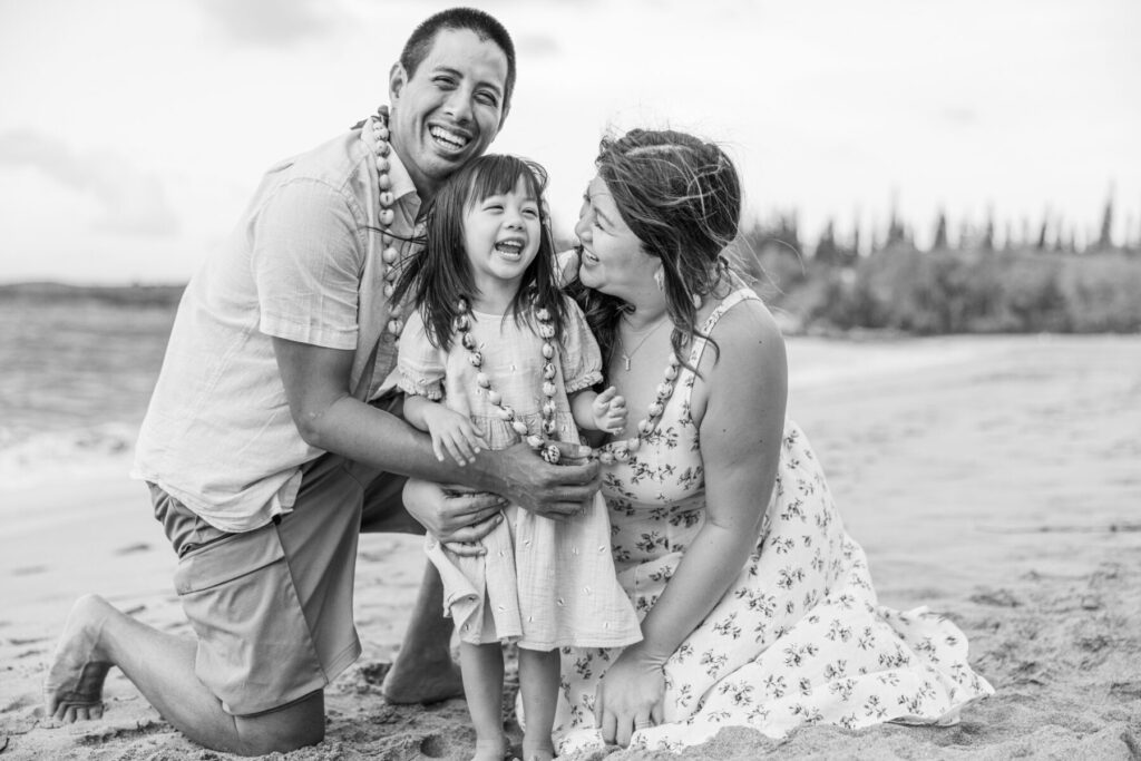 Family hugging and smiling at DT Fleming Beach 