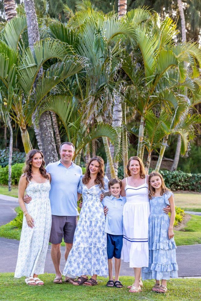 Maui family photoshoot with Capture Aloha Photography featuring a family portrait surrounded by lush tropical greenery at DT Fleming Beach.
