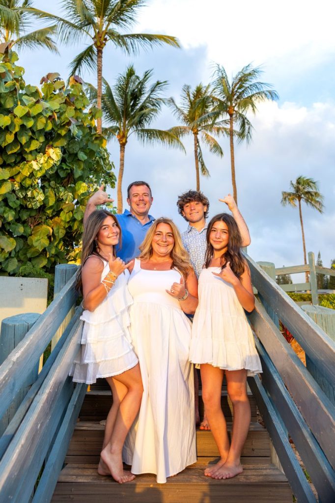Maui family photoshoot with tropical greenery at Kapalua Beach. 