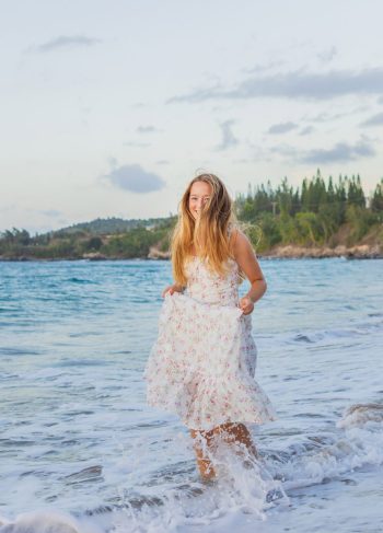 girl standing barefoot on the beach in Maui