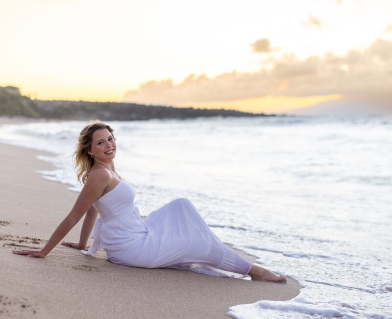 Maui senior photographer – graduate smiling at DT Fleming during golden hour.