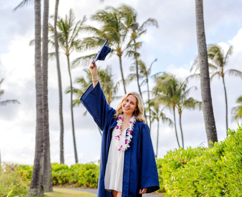 Maui senior photos – graduate posing by palm trees with cap and gown