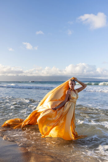 Flying dress photoshoot Maui – woman twirling at beach