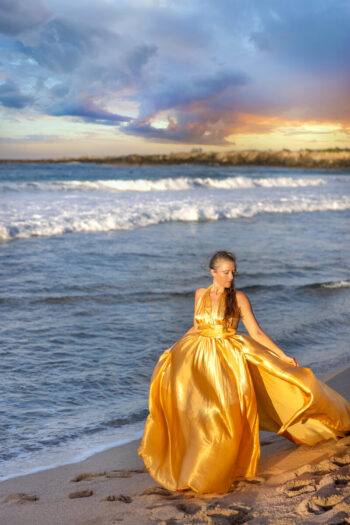 Flying dress photoshoot Maui – woman twirling at beach