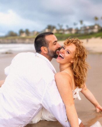 Maui couples photographer – playful kiss on the rocks at Ironwoods Beach.