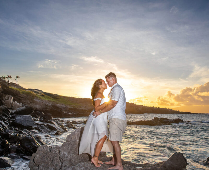 Engagement session, Maui – backlit hug on lava point at sunset.– backlit hug on lava point at sunset.