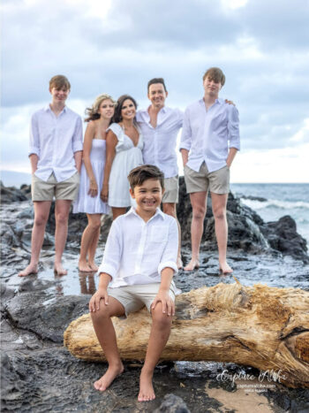 Maui family photography on rocky shoreline at golden hour.