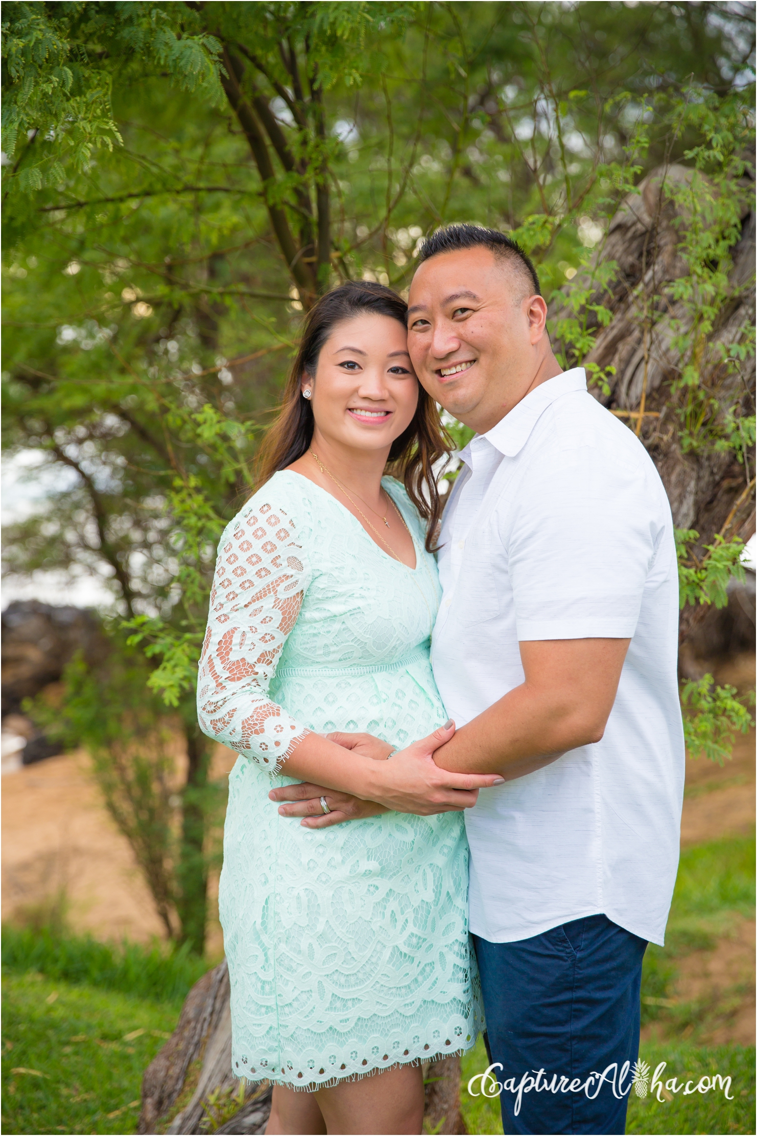 couple expecting a baby on a maui beach