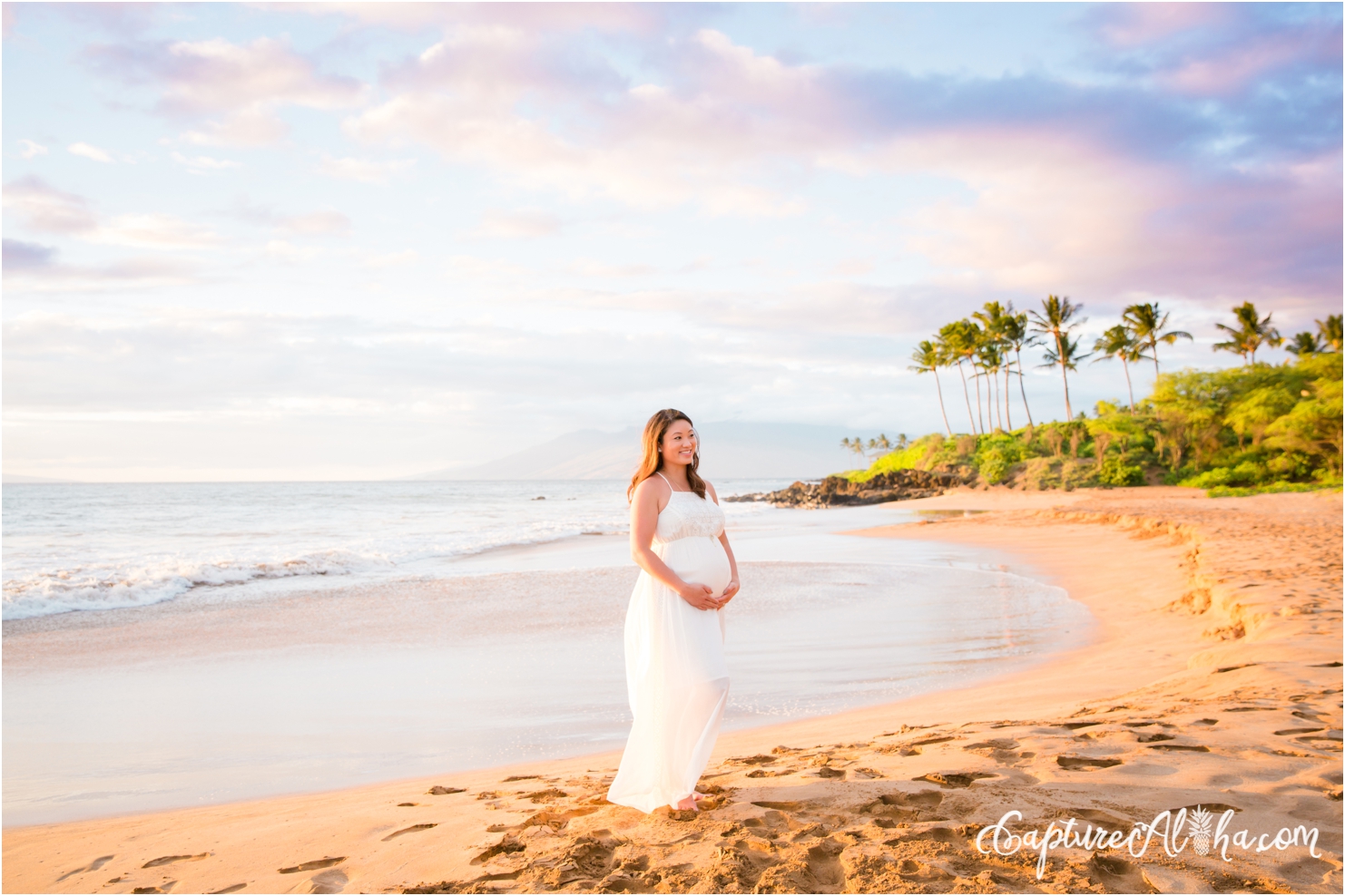 maternity portrait on a Maui beach at sunset in a white dress