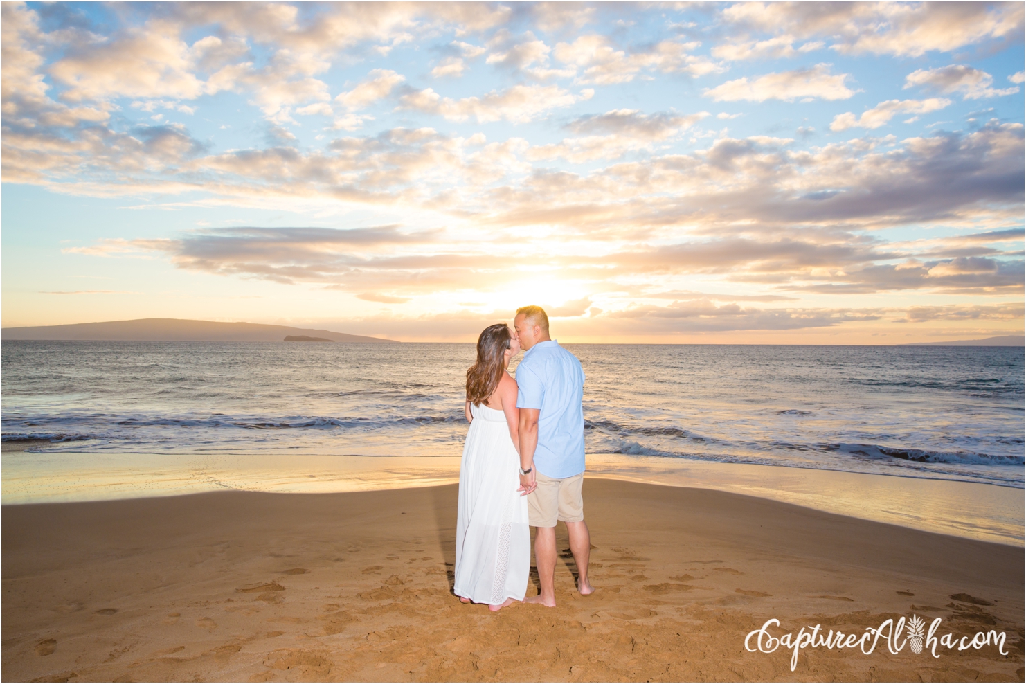 couple kissing on the beach at sunset