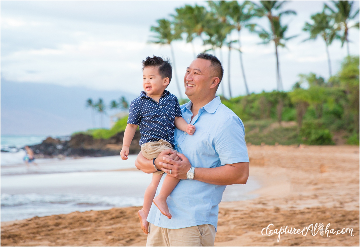 father and son on a Maui beach at sunset