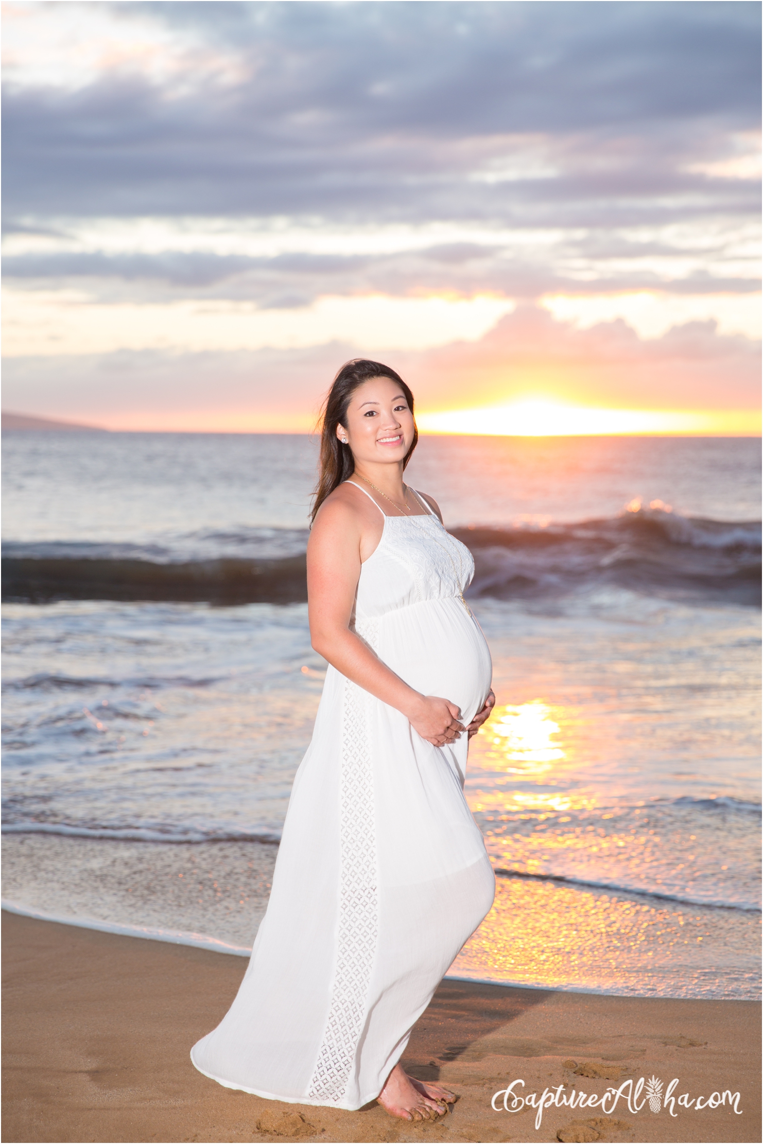 maternity portrait on a Maui beach at sunset in a white dress