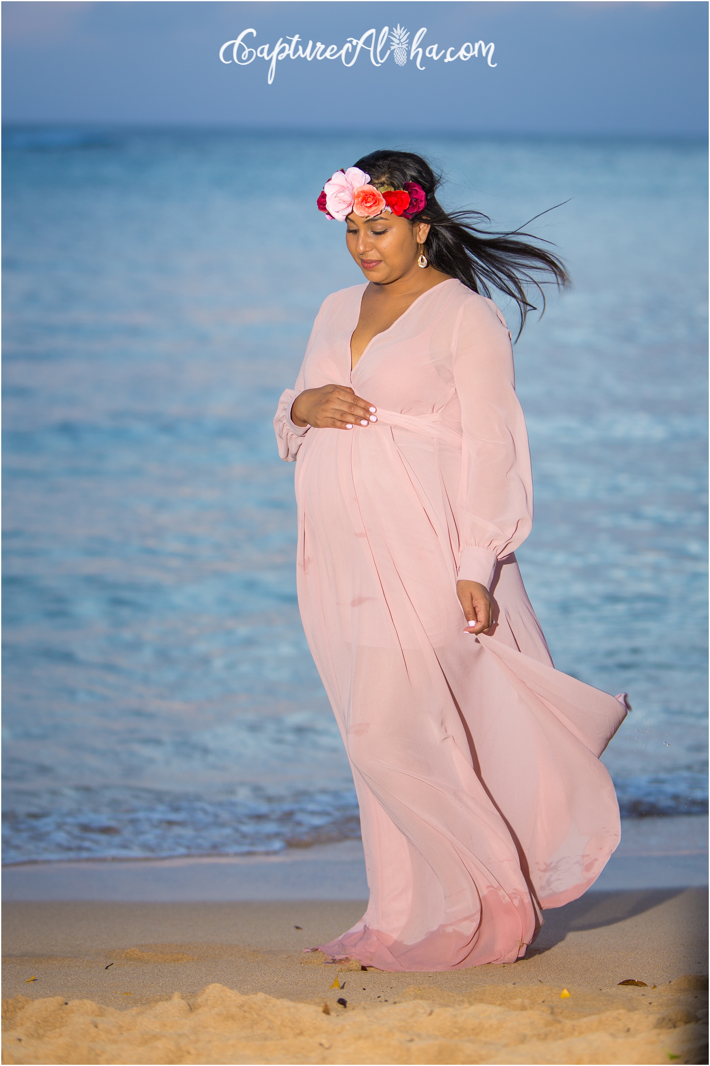 Maui Maternity Photography of mom on the beach in a blush pink dress and flower crown