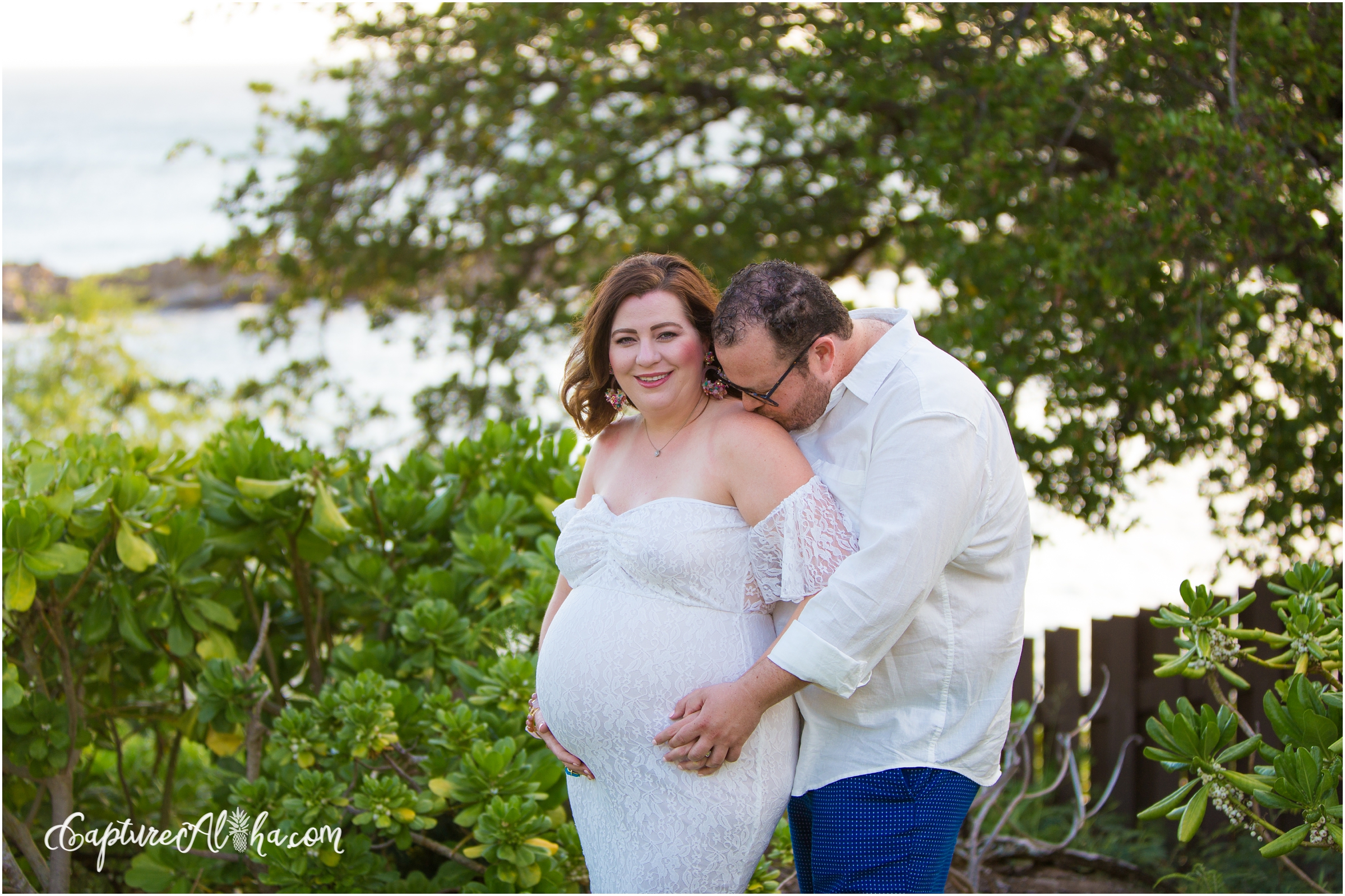 Maui Maternity Photographer at Kapalua Bay with Pregnant couple surrounded by greenery