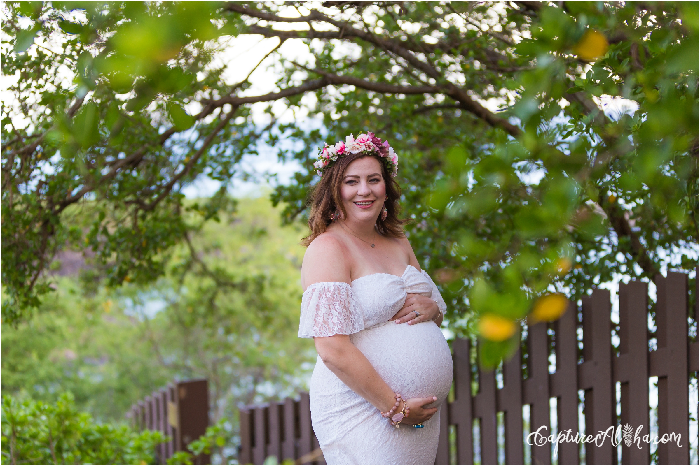 Maui Maternity Photographer at Kapalua Bay with Pregnant woman surrounded by greenery
