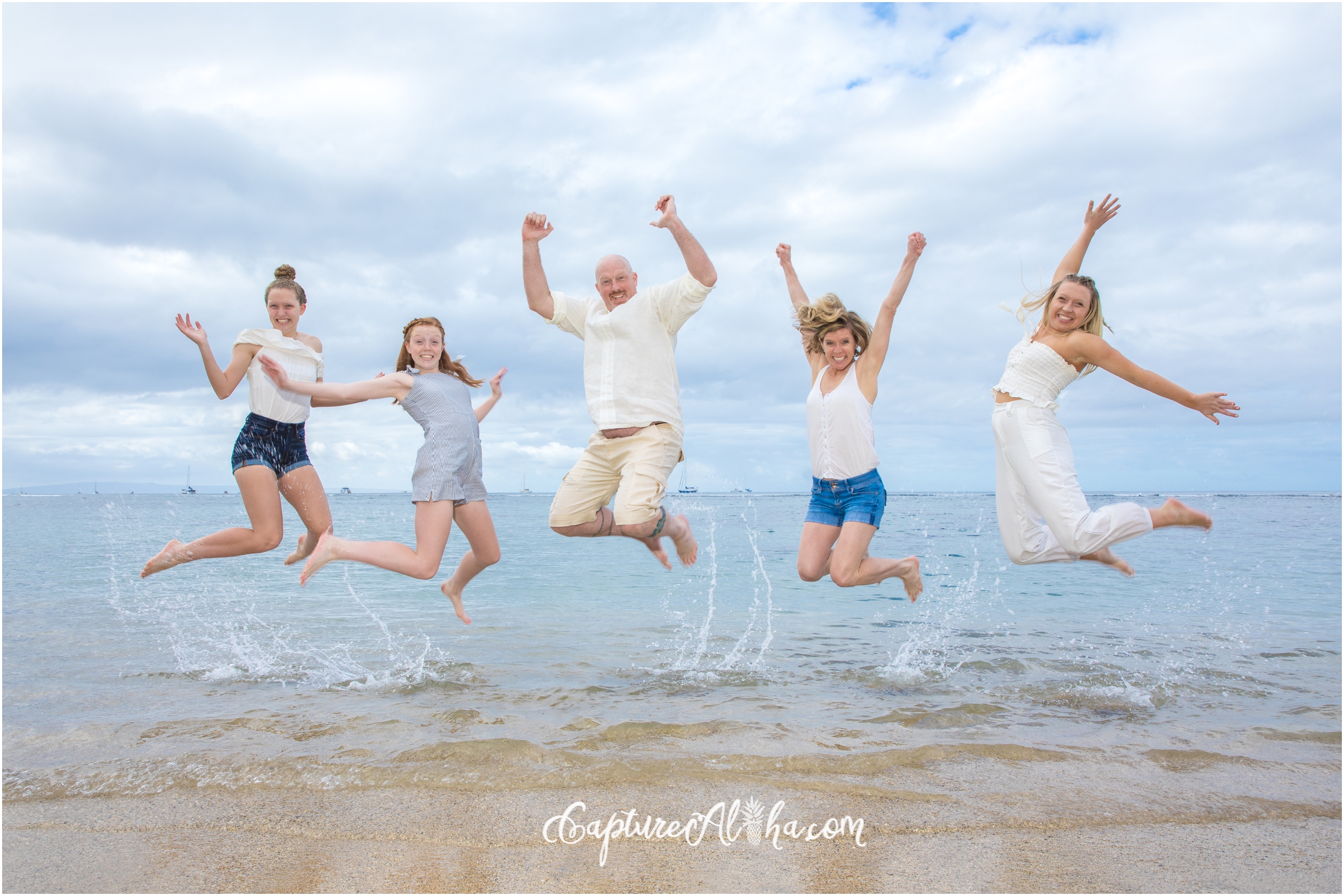Family Photo of everyone jumping at Baby Beach