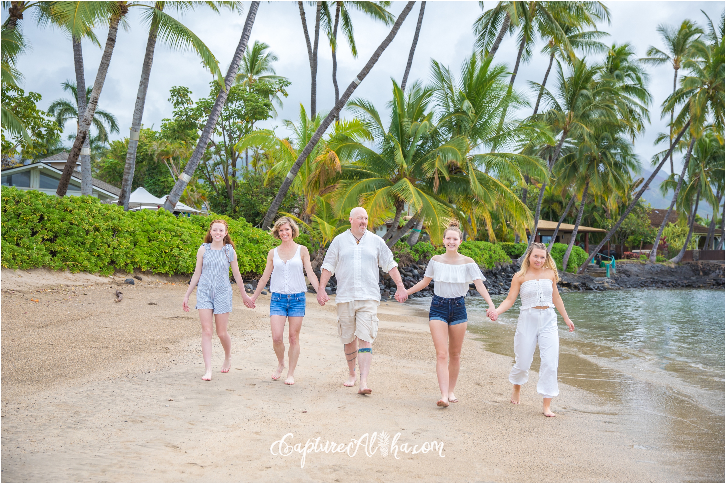 Family Photography at Baby Beach of family walking and holding hands on the beach