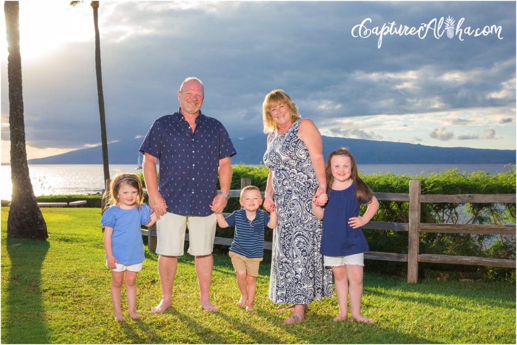 Maui Family Photography at Kapalua Bay with four people at sunset on the grass