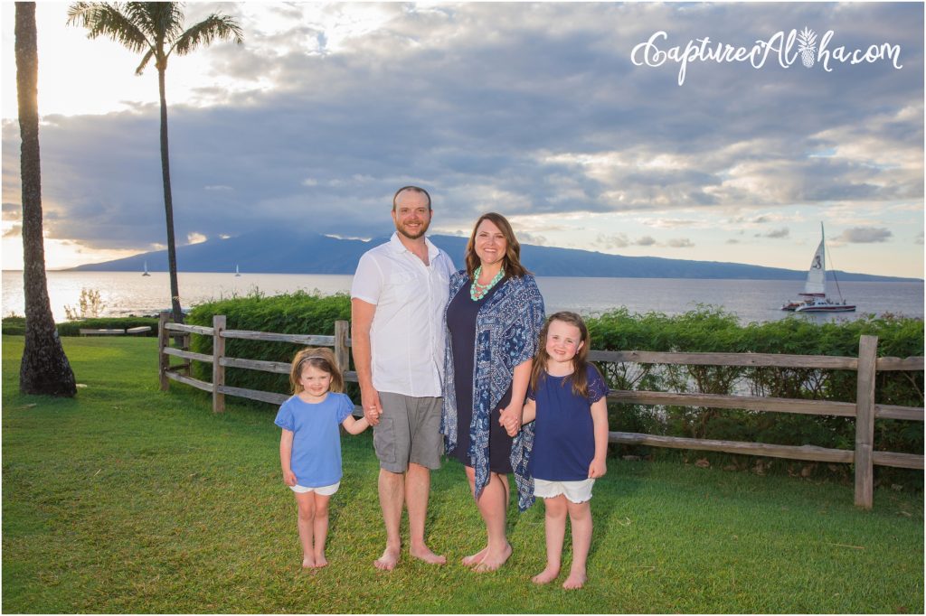 Maui Family Photography at Kapalua Bay with four people at sunset on the grass
