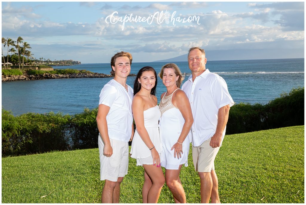 Family Portrait of 4 people all wearing white at Kapalua Bay beach on Maui