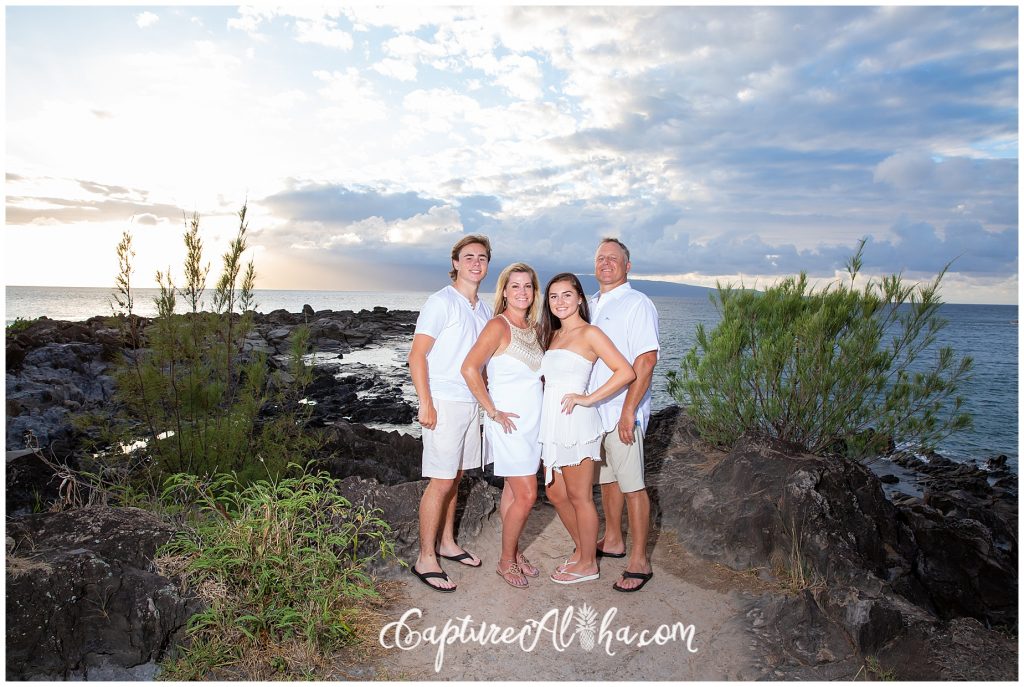 Family Portrait of 4 people all wearing white at Kapalua Bay beach on Maui