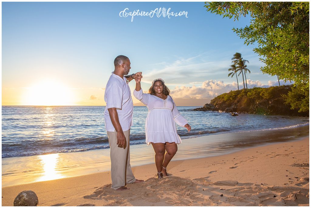 Maui Couples Photography on Kapalua Bay Beach at Sunset with palm trees in the distance