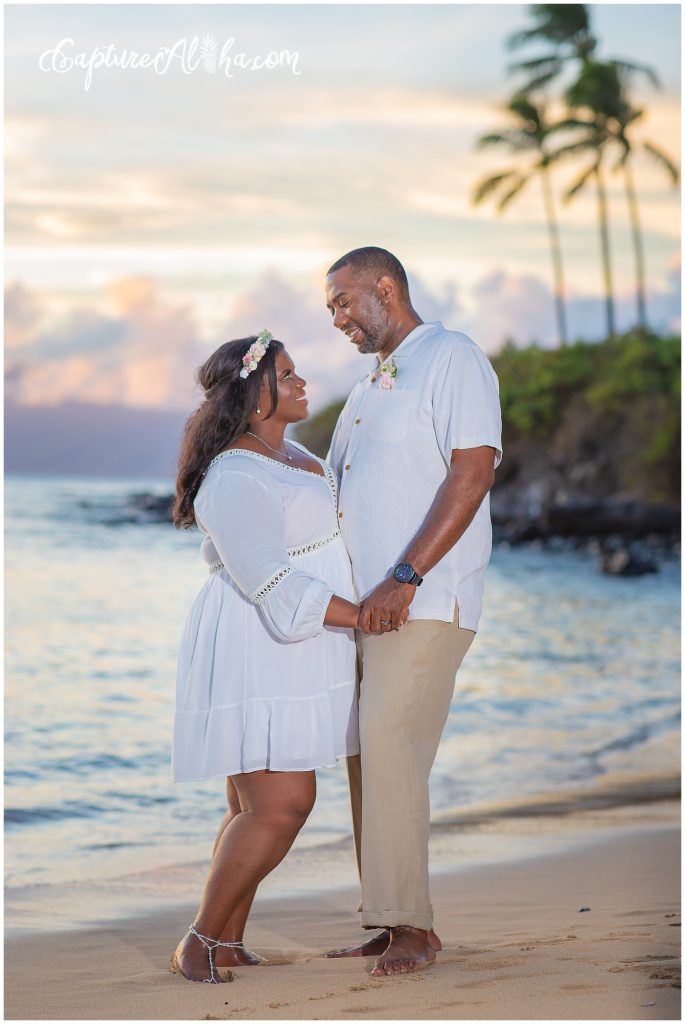 Maui Couples Photography on Kapalua Bay Beach at Sunset with palm trees in the distance