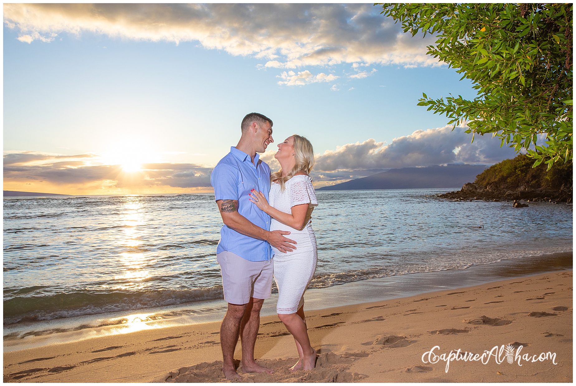 Wife and husband on a maternity photoshoot in Maui on the beach
