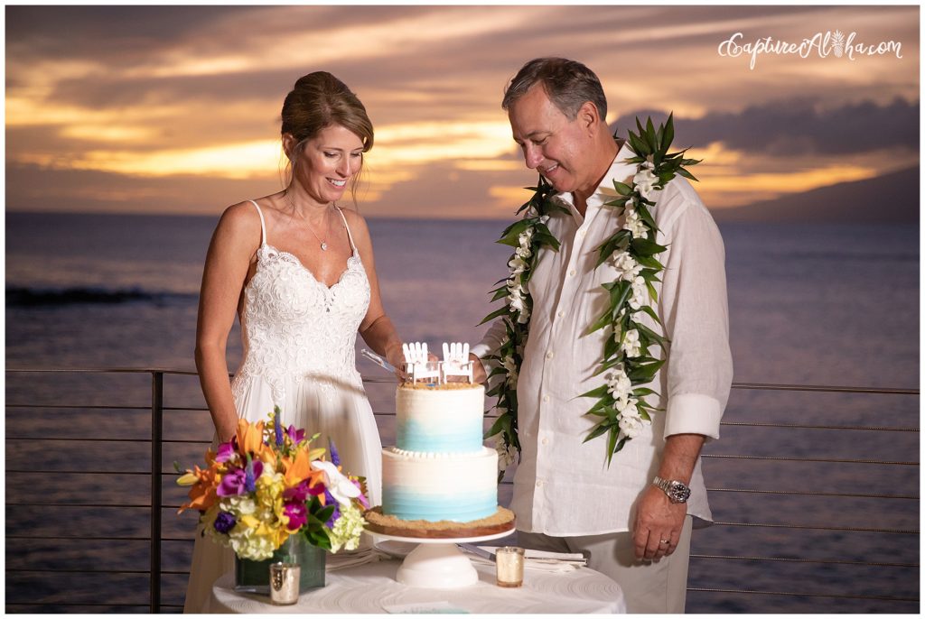 Wedding at The Cliff House Kapalua Bay bride and groom cut the cake