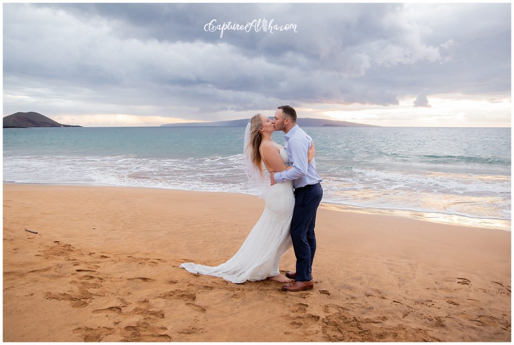 Maui Wedding Photography at Po'olenalena Beach, bride and groom kissing with the sunset