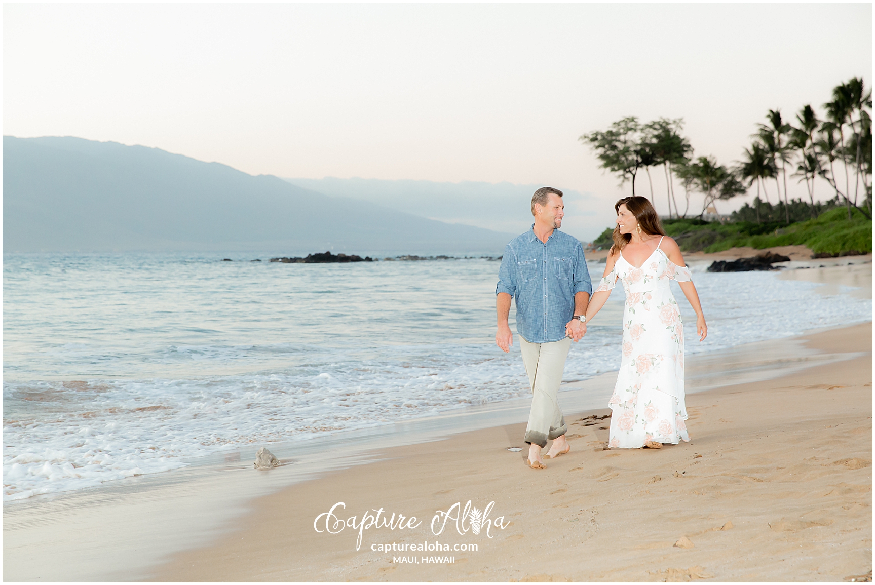 Maui Couples Photography at Mokapu Beach, Maui at sunset with couple walking on the beach